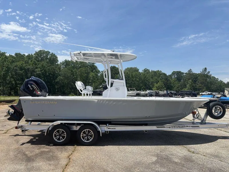 Slide: The Image of 2024 Sportsman Masters 227 Bay boat on trailer, parked outdoors under clear sky. - 6