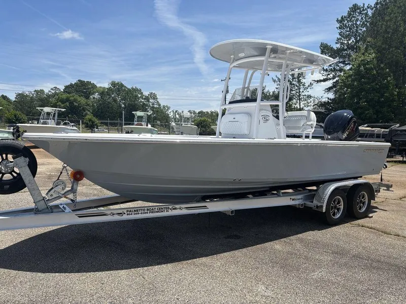 Slide: The Image of 2024 Sportsman Masters 227 Bay boat on trailer, parked outdoors. - 7