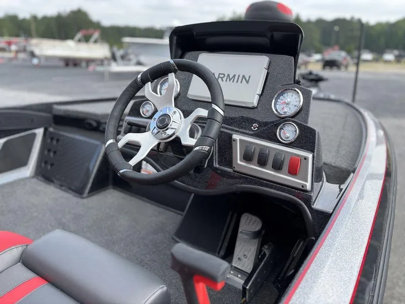 Slide: The Image of 2025 Nitro Z19 Pro boat dashboard with steering wheel and Garmin display. - 13