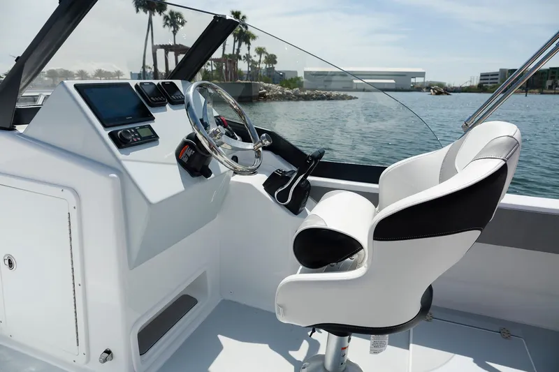 Slide: The Image of Modern ArrowCat 20DC boat cockpit with sleek design, 2025 model, on a sunny day by the water. - 5