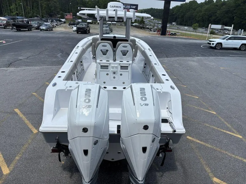 Slide: The Image of 2025 Sportsman OPEN 262 boat with dual engines, parked in a lot. - 11