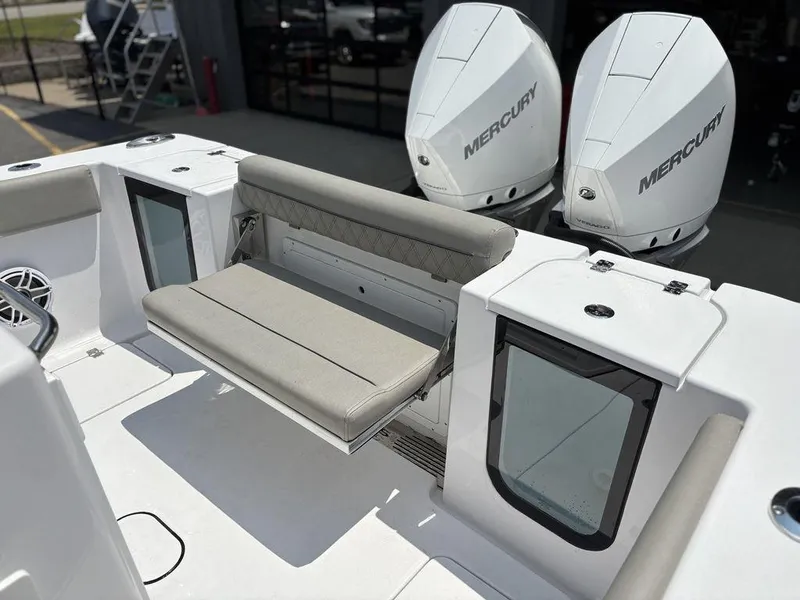 Slide: The Image of 2025 Sportsman OPEN 262 boat with dual Mercury engines and foldable seating. - 12