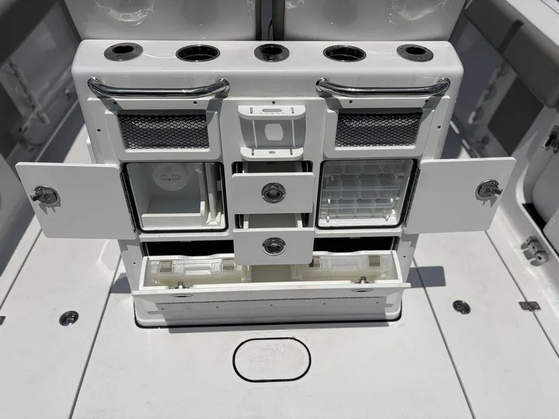 Slide: The Image of 2025 Sportsman OPEN 262 boat storage compartments with drawers and holders, showcasing organized fishing gear space. - 15