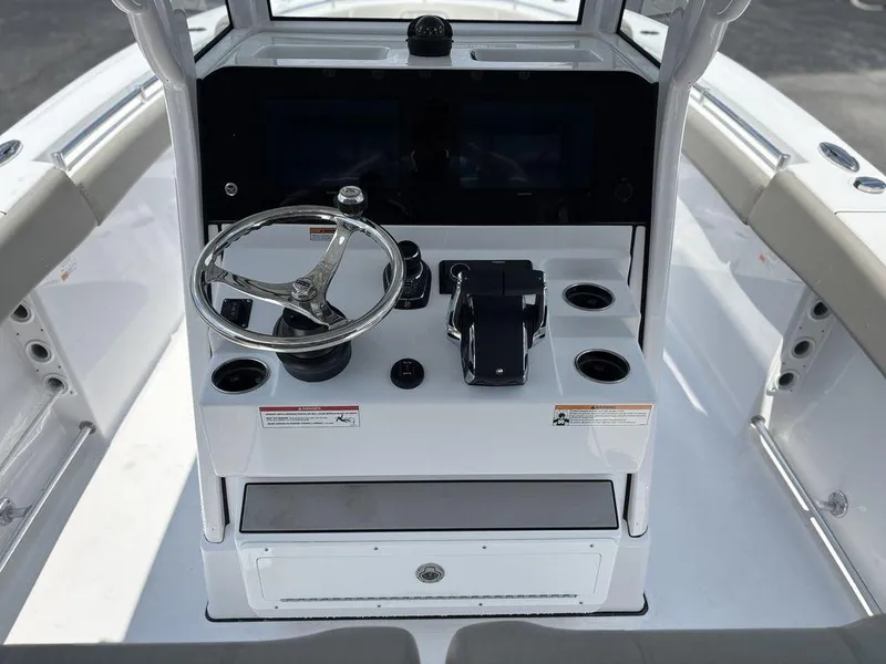Slide: The Image of 2025 Sportsman OPEN 262 boat console with steering wheel and controls. - 19