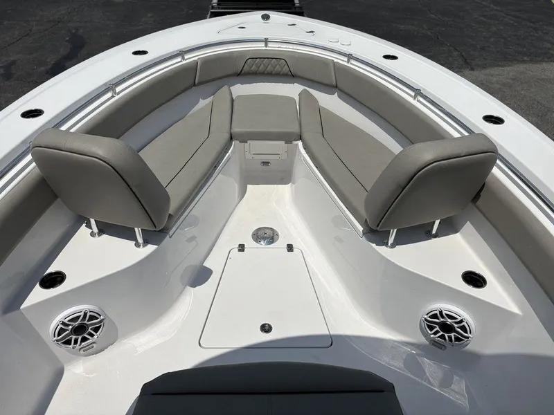 Slide: The Image of 2025 Sportsman OPEN 262 boat interior with cushioned seating and speakers. - 24