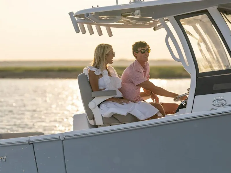 Slide: The Image of Couple enjoying a ride on a 2025 Sportsman OPEN 262 boat at sunset. - 27