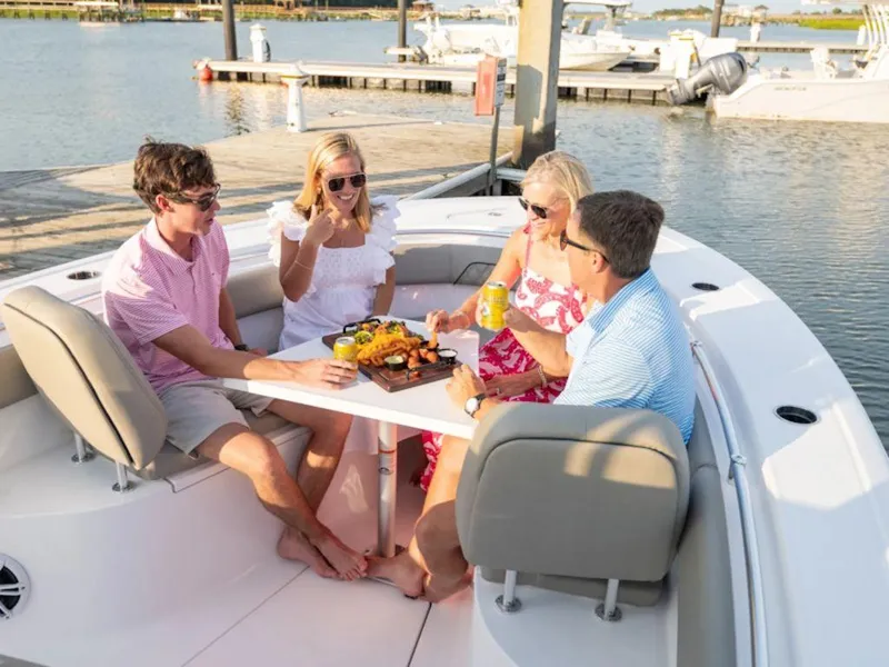 Slide: The Image of Four people enjoying a meal on a 2025 Sportsman OPEN 262 boat. - 31