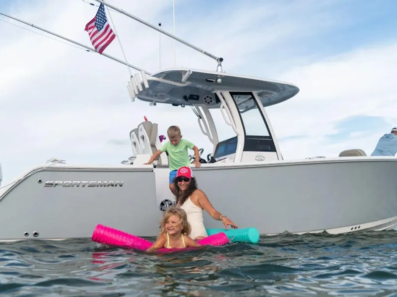 Slide: The Image of Family enjoying water near 2025 Sportsman OPEN 262 boat with American flag. - 32