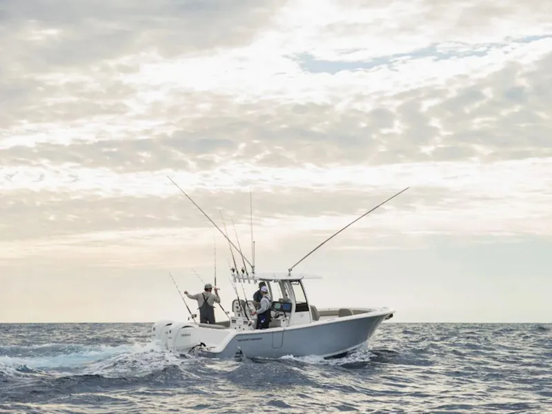 Slide: The Image of 2025 Sportsman OPEN 262 boat navigating ocean waves under cloudy sky. - 33