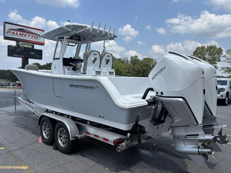 Slide: The Image of 2025 Sportsman OPEN 262 boat on trailer with dual Mercury engines, parked outdoors. - 5