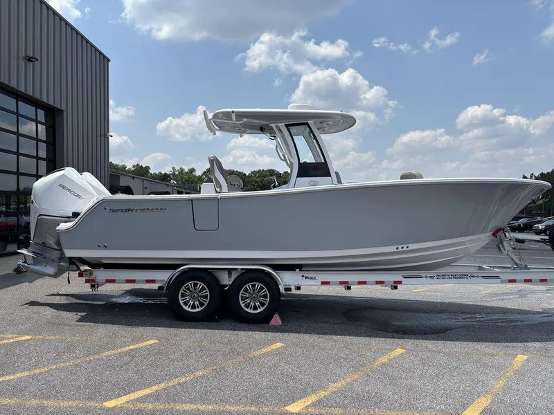 Slide: The Image of 2025 Sportsman OPEN 262 boat on trailer, parked outdoors under a cloudy sky. - 6