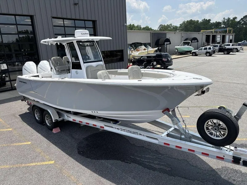Slide: The Image of 2025 Sportsman OPEN 262 boat on trailer in parking lot, sunny day. - 9