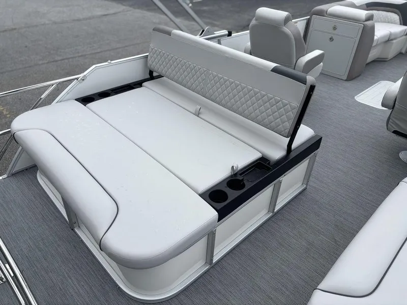 Slide: The Image of 2025 Godfrey SWEETWATER 2286 SFL boat interior with luxurious seating and cup holders. - 14