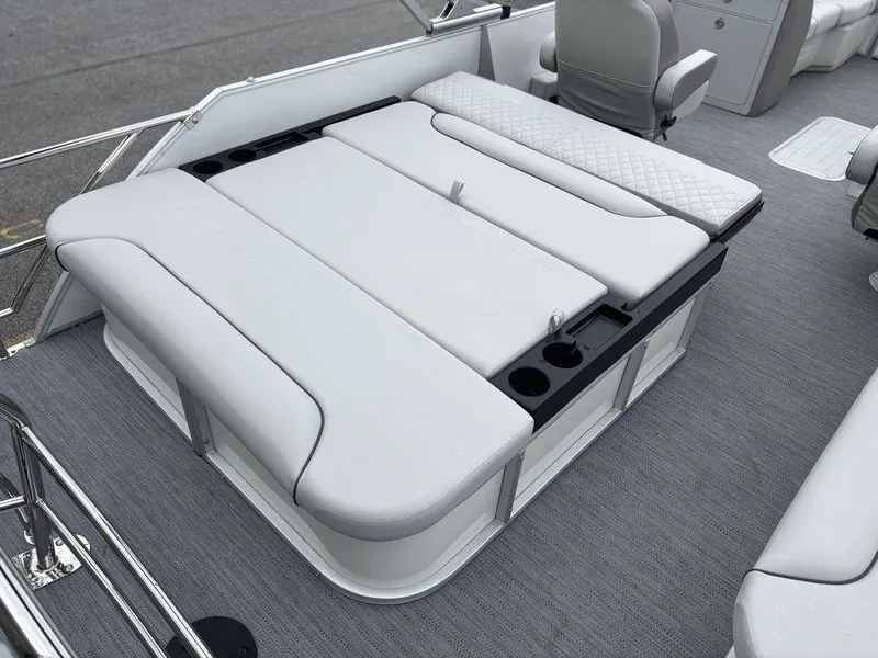 Slide: The Image of 2025 Godfrey SWEETWATER 2286 SFL boat interior with cushioned seating and cup holders. - 15