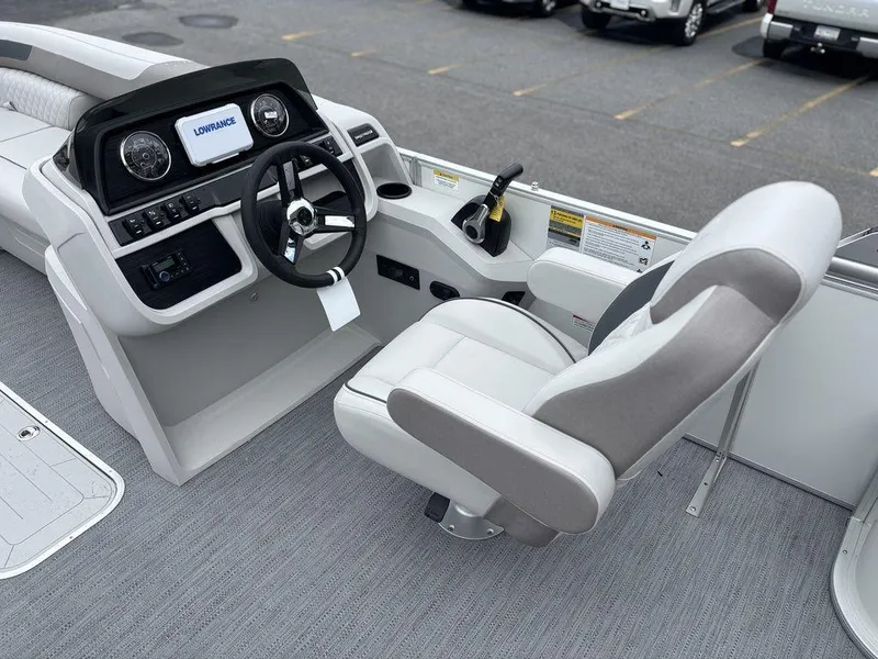 Slide: The Image of 2025 Godfrey SWEETWATER 2286 SFL boat interior with steering console and captain's chair. - 16