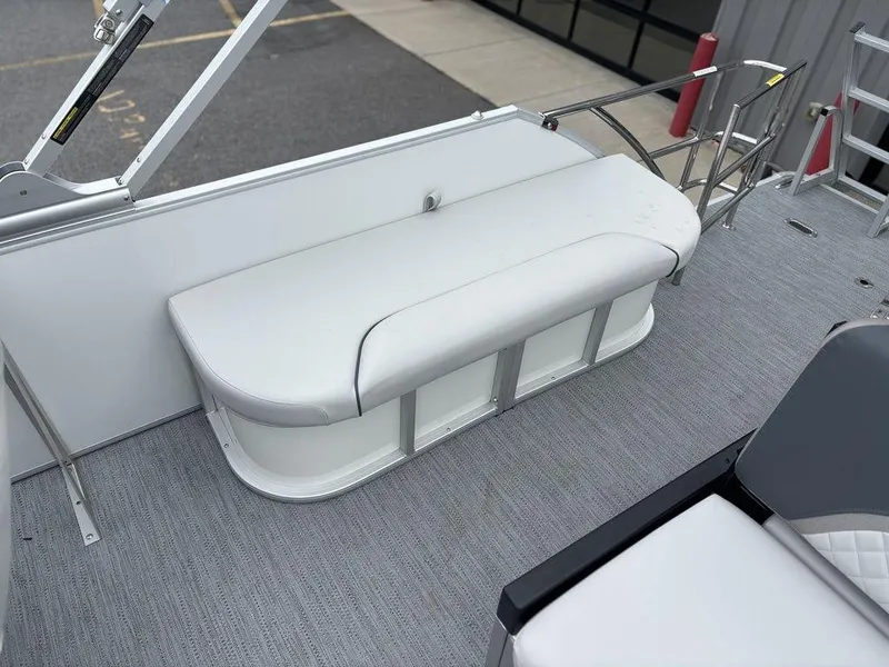 Slide: The Image of 2025 Godfrey SWEETWATER 2286 SFL boat interior with white cushioned seating. - 17