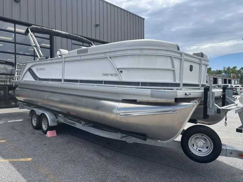 Slide: The Image of 2025 Godfrey SWEETWATER 2286 SFL pontoon boat on trailer, parked outdoors. - 6