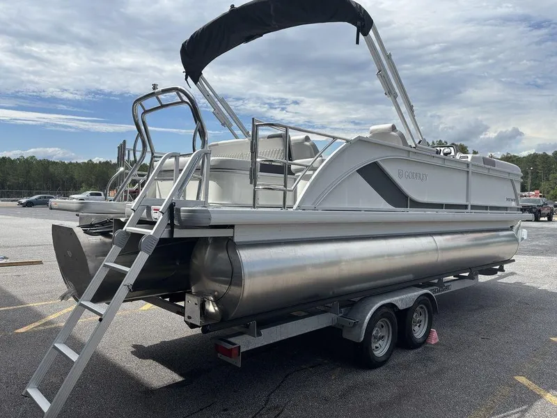 Slide: The Image of 2025 Godfrey SWEETWATER 2286 SFL pontoon boat on trailer, parked outdoors. - 9