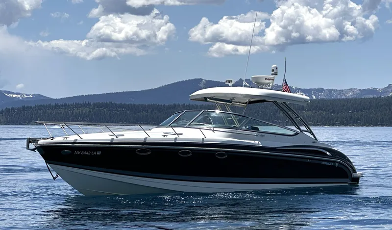 The Image of 2017 Formula 370 Super Sport boat on a serene lake with mountainous backdrop. - 0