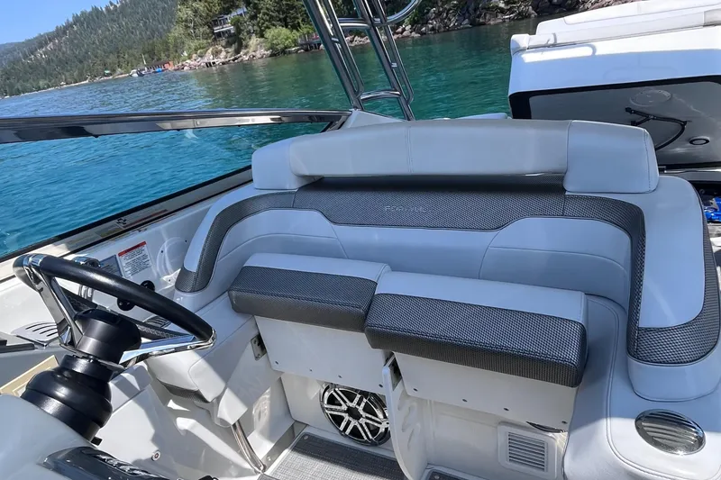 Slide: The Image of 2017 Formula 370 Super Sport boat interior with seating, steering wheel, and lake view. - 15