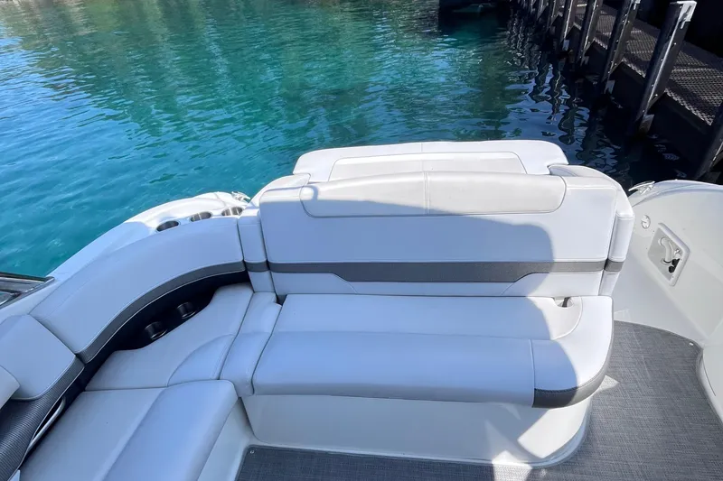 Slide: The Image of 2017 Formula 370 Super Sport boat with white seating, docked by clear blue water. - 18