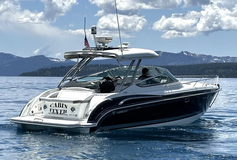 Slide: The Image of 2017 Formula 370 Super Sport boat on a scenic lake with mountains in the background. - 2