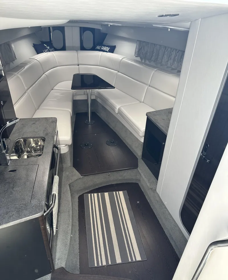 Slide: The Image of Interior of 2017 Formula 370 Super Sport boat with white seating and kitchenette. - 26