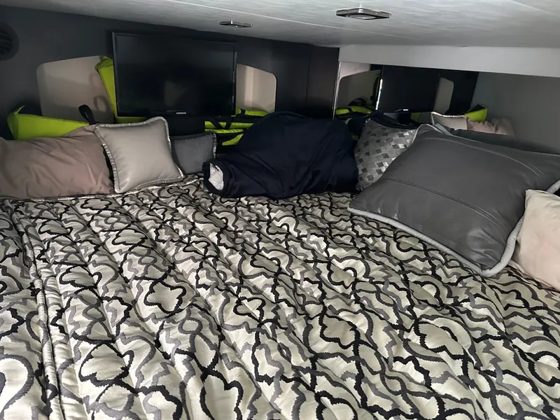 Slide: The Image of Cozy cabin interior of 2017 Formula 370 Super Sport with patterned bedding and pillows. - 35