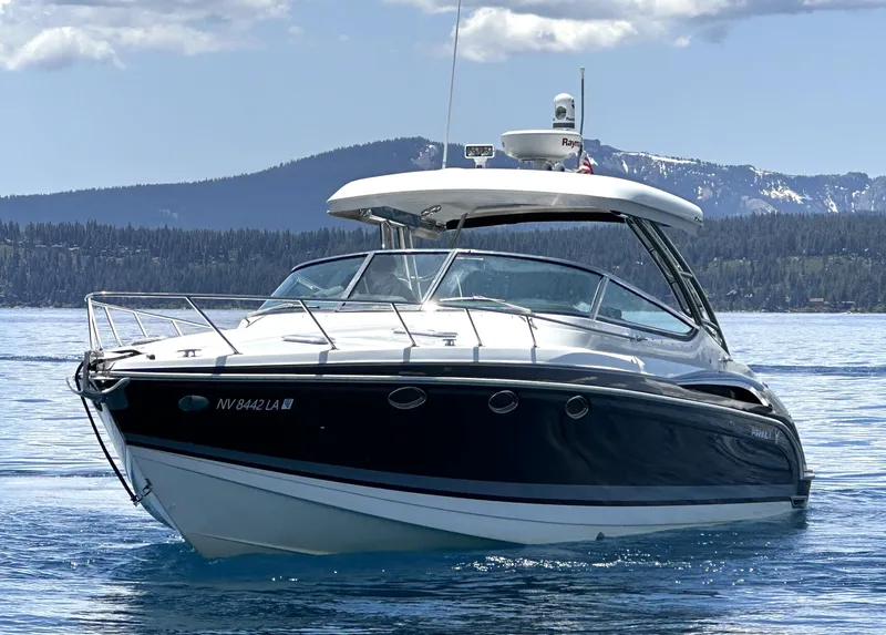 Slide: The Image of 2017 Formula 370 Super Sport boat cruising on a scenic lake with mountains. - 4