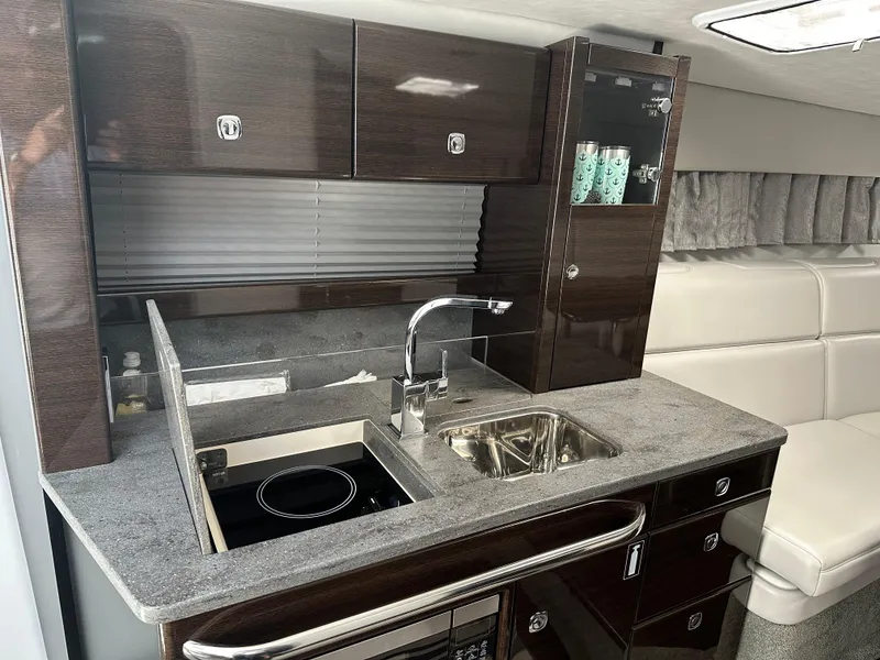 Slide: The Image of 2017 Formula 370 Super Sport yacht interior kitchen with modern cabinetry and sink. - 40