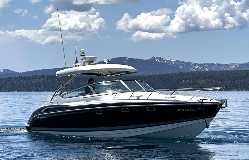 Slide: The Image of 2017 Formula 370 Super Sport boat cruising on a scenic lake with mountains. - 5