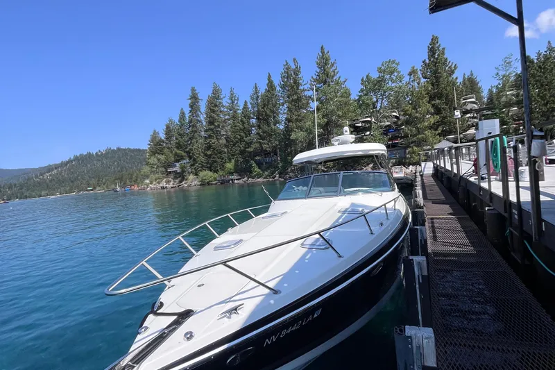 Slide: The Image of 2017 Formula 370 Super Sport boat docked on a serene lake with forested shoreline. - 9