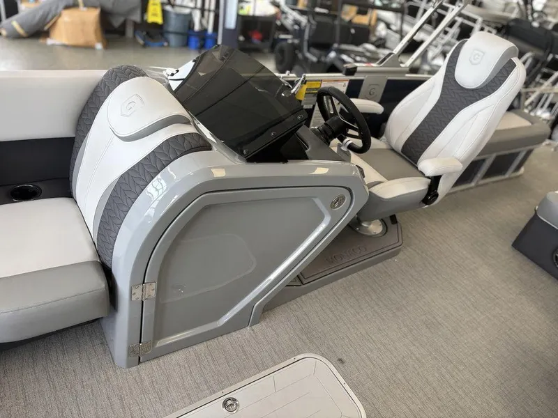 Slide: The Image of 2025 Godfrey Monaco 235 SFL boat interior with modern helm and seating. - 11