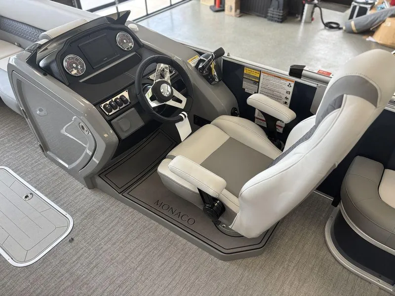 Slide: The Image of 2025 Godfrey Monaco 235 SFL boat cockpit with modern steering and controls. - 20