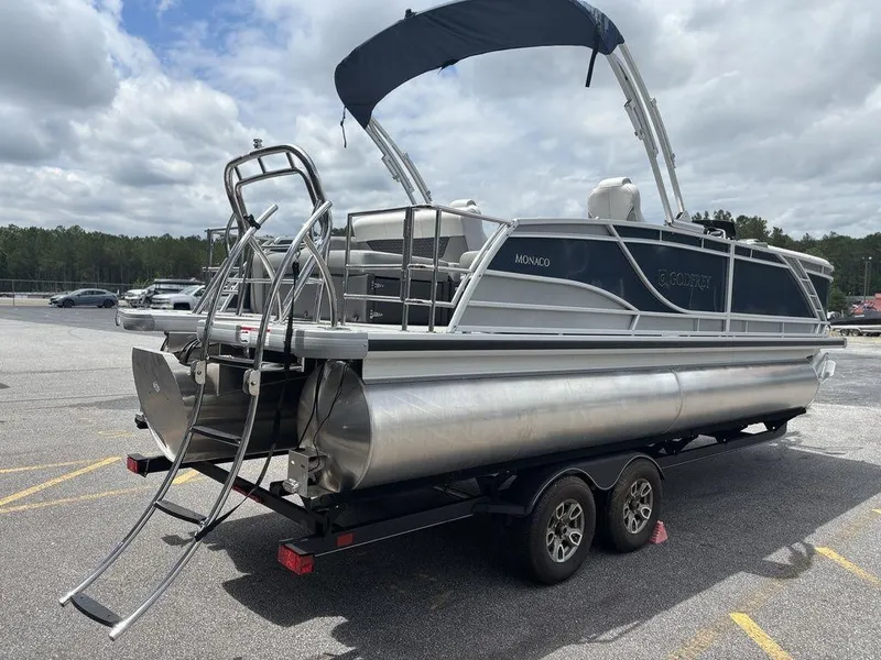Slide: The Image of 2025 Godfrey Monaco 235 SFL pontoon boat on trailer, parked outdoors. - 3