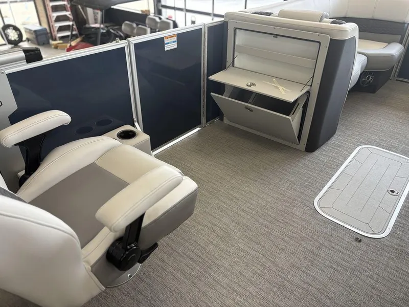 Slide: The Image of Interior of 2025 Godfrey Monaco 235 SFL pontoon boat with seating and storage compartments. - 9