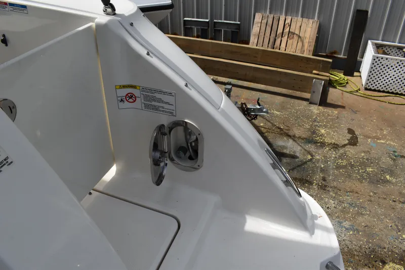 Slide: The Image of 2011 Sea Ray 310 Sundancer boat deck with warning label and open hatch. - 10