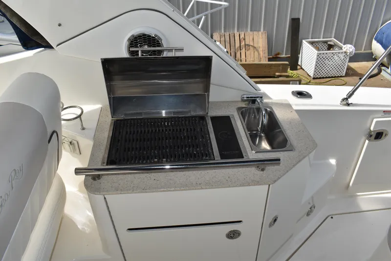 Slide: The Image of 2011 Sea Ray 310 Sundancer boat with outdoor grill and sink on deck. - 14