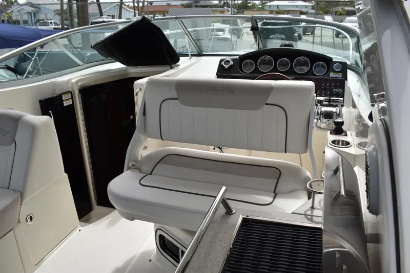 Slide: The Image of 2011 Sea Ray 310 Sundancer cockpit with helm, seating, and control panel. - 18