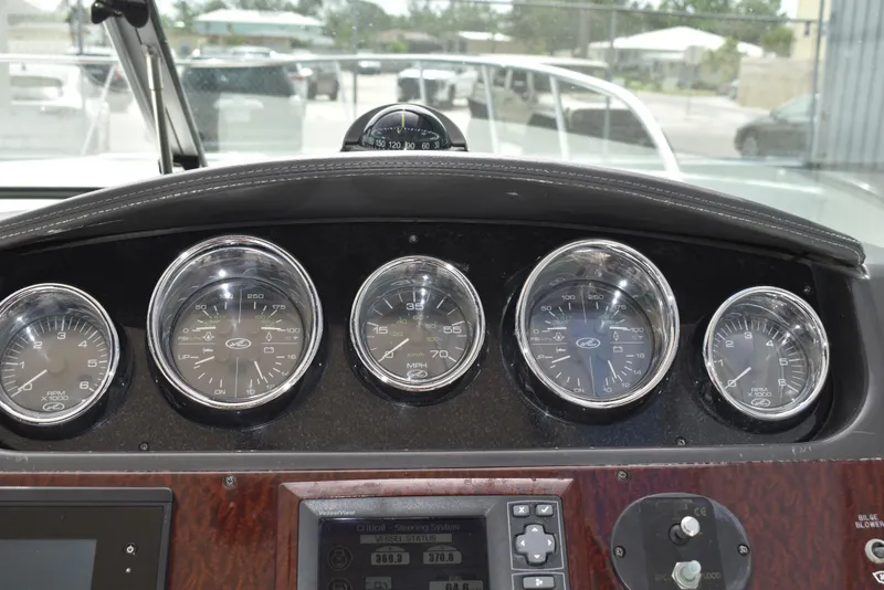 Slide: The Image of Dashboard of a 2011 Sea Ray 310 Sundancer boat with gauges and controls. - 20