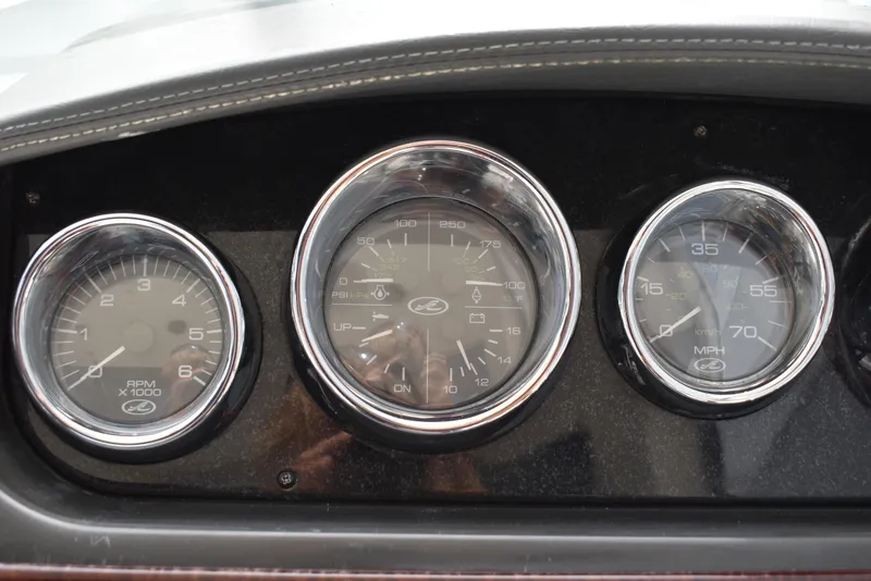 Slide: The Image of Dashboard gauges of a 2011 Sea Ray 310 Sundancer boat. - 21