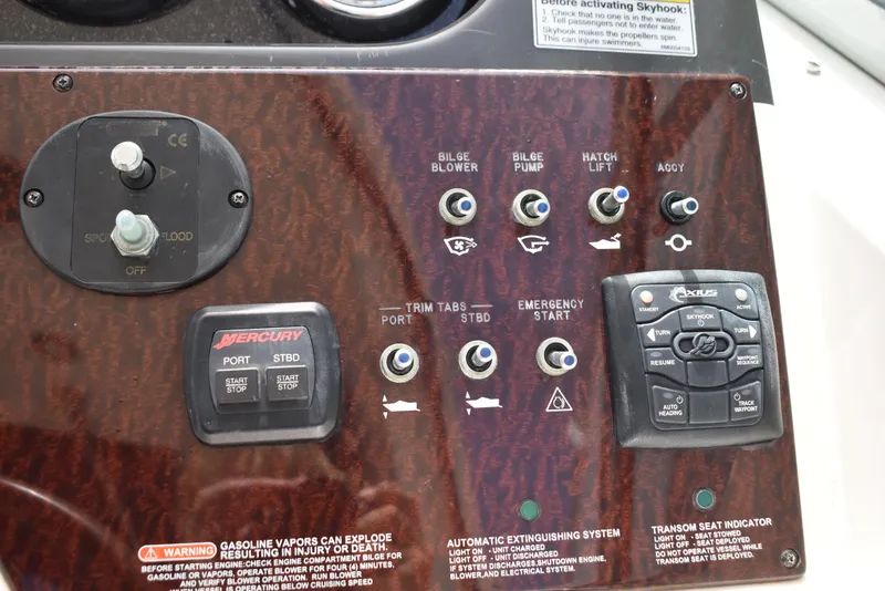Slide: The Image of Control panel of a 2011 Sea Ray 310 Sundancer boat with various switches and buttons. - 23