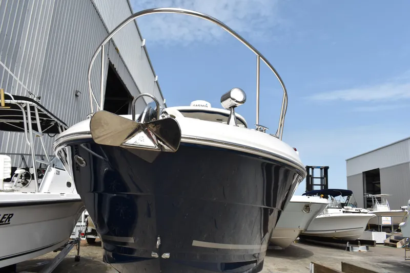 Slide: The Image of 2011 Sea Ray 310 Sundancer boat docked near a warehouse. - 3