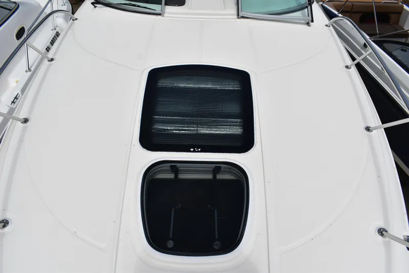 Slide: The Image of 2011 Sea Ray 310 Sundancer boat deck with skylights and railing. - 30