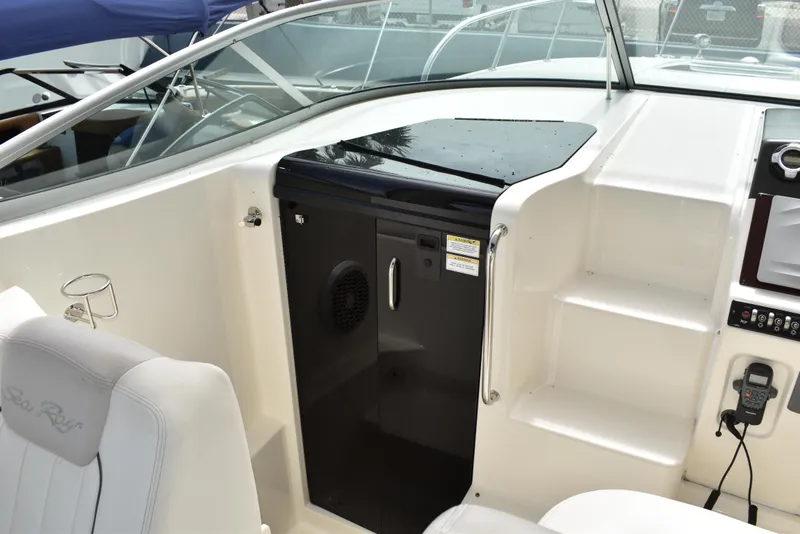 Slide: The Image of 2011 Sea Ray 310 Sundancer cockpit with seating and control panel. - 34