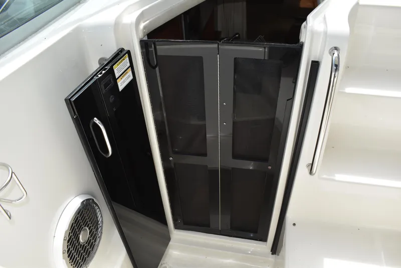 Slide: The Image of 2011 Sea Ray 310 Sundancer cabin entrance with black door and speaker. - 35