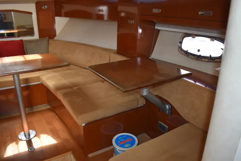 Slide: The Image of Interior of 2011 Sea Ray 310 Sundancer with cozy seating and wooden table. - 37