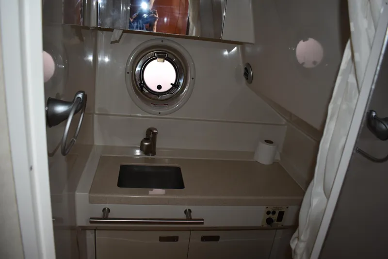Slide: The Image of Bathroom interior of 2011 Sea Ray 310 Sundancer yacht with sink and porthole. - 40