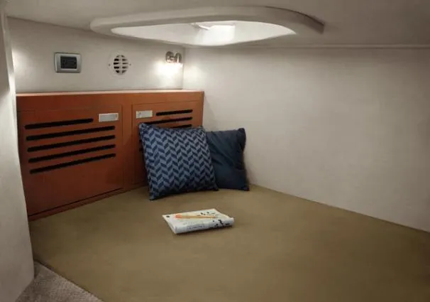 Slide: The Image of Cozy cabin interior of 2011 Sea Ray 310 Sundancer with pillows and book. - 47