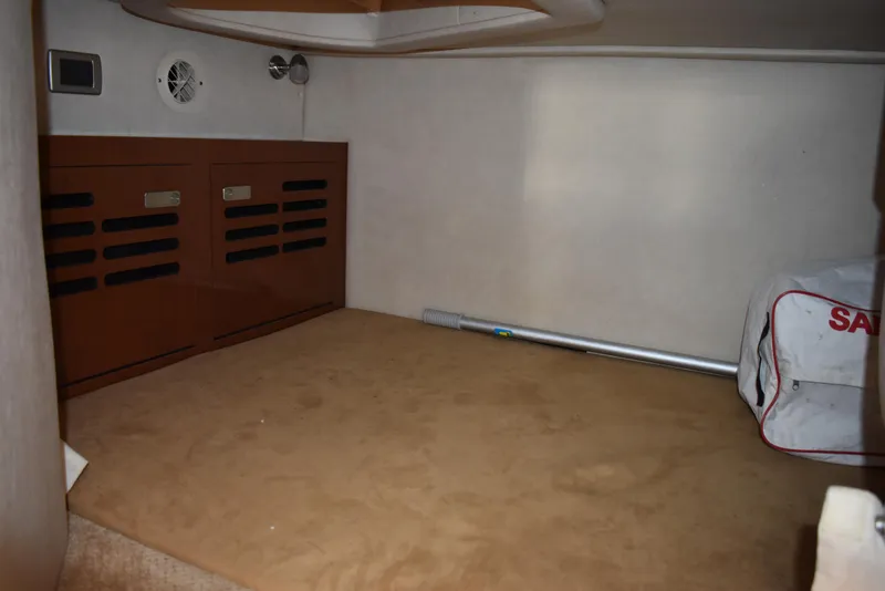 Slide: The Image of Interior cabin space of 2011 Sea Ray 310 Sundancer boat, featuring storage and equipment. - 48